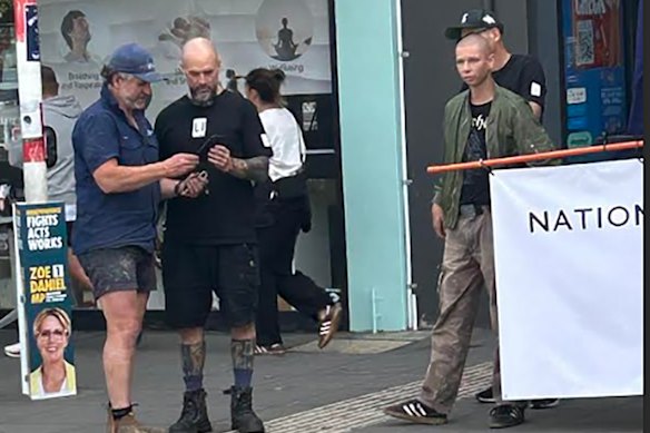 Matt Trihey (centre) outside a Goldstein polling booth on election day last year.