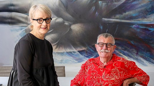 Sandra Powell and Andrew King sit in front of their full-wall Kid Zoom mural, among just a few of the many other works in their collection.