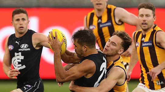 Gotcha: Hawthorn's Jack Scrimshaw gets his hands on Carlton's Jack Martin.
