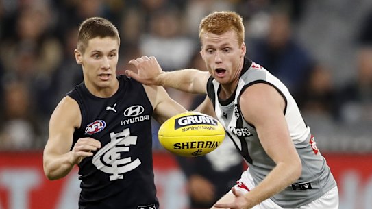 Carlton’s Lachie Fogarty vies with Port Adelaide’s Willem Drew.