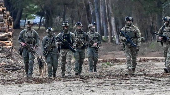 Special operations group police take part in the hunt for Dezi Freeman.