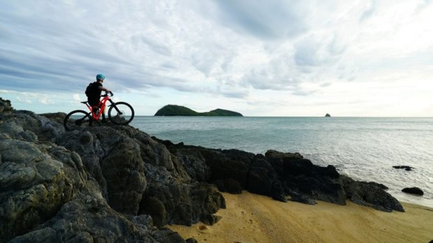 A mountain bike rider at Palm Cove on the Wangetti Trail, one of four ecotourism pilots the Queensland government will delay.