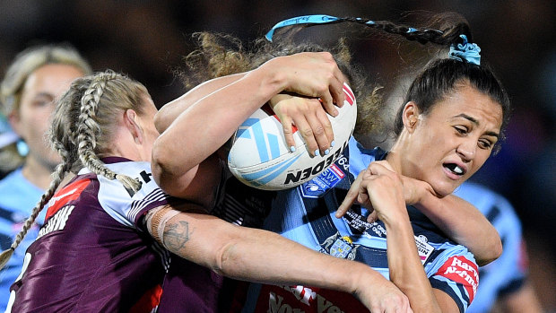 Ratings winner: Corban McGregor of NSW is tackled by Ali Brigginshaw and Chelsea Lenarduzzi at North Sydney Oval.