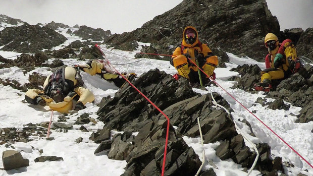 Two sherpas retrieve the body of Indian climber Goutam Ghosh (left) in May 2017. He had died near the summit a year earlier.