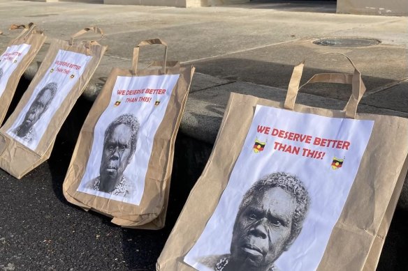 Paper bags bearing the face of Truganini, the first Aboriginal person repatriated, were used in a protest at the Tasmanian parliament.