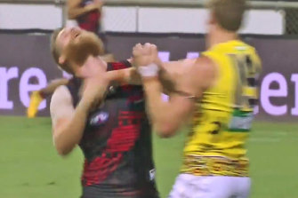 Tom Lynch clashes with Essendon's Michael Hurley on Saturday night.