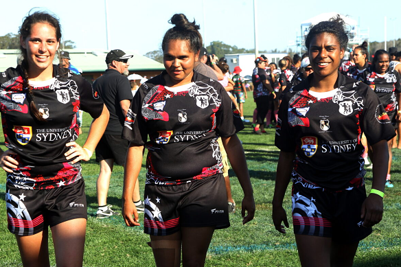 Three players from the victorious Redfern All Blacks women’s team walk off the field after the 2014 Koori Knockout final. 