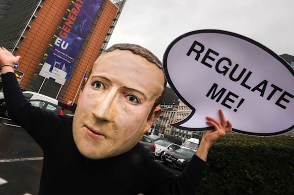 A campaigner from the global citizens movement Avaaz wearing a mask of Facebook CEO Mark Zuckerberg.