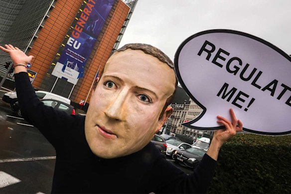 A campaigner from the global citizens movement Avaaz wearing a mask of Facebook CEO Mark Zuckerberg.
