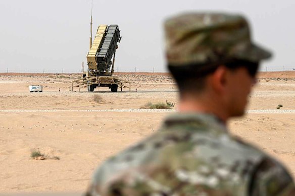 A member of the US Air Force stands near a Patriot missile battery in Saudi Arabia. The US Central Command has requested longer-range missiles for potential use in Iran.