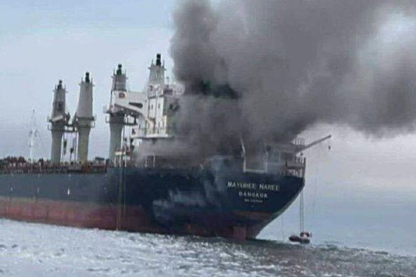 The burning of a Thai cargo ship in the Strait of Hormuz, reflecting the danger of Iranian attack.