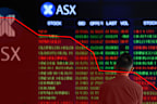 A man stands in front of digital market boards at the Australian Stock Exchange (ASX) in Sydney, Monday, March 2, 2020. The Australian share market spiralled nearly 2.5 per cent lower as the deadly coronavirus spreads across the planet and stifles trading prospects. (AAP Image/Joel Carrett) NO ARCHIVING