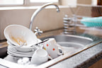 Shot of kitchen sink full of dirty dishes