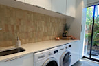 Rachel and Ryan Carr renovated their laundry for just under $700 by doing the tiling and painting themselves.