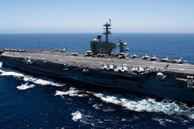 The aircraft carrier USS Theodore Roosevelt transits the Pacific Ocean in 2019. Theodore Roosevelt is conducting operations in the South China Sea.