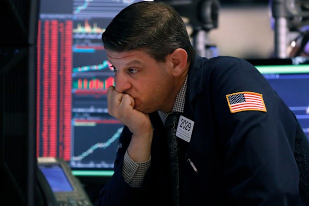 Trader Michael Gallucci works at his post on the floor of the New York Stock Exchange today. Trading was halted as stocks plummeted on the back of coronavirus concerns.