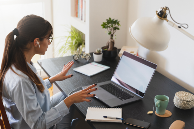 Woman sitting at a desk appearing to be working from home