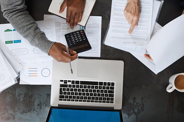 Superannuation crunching numbers laptop calculator doing finances tax return 