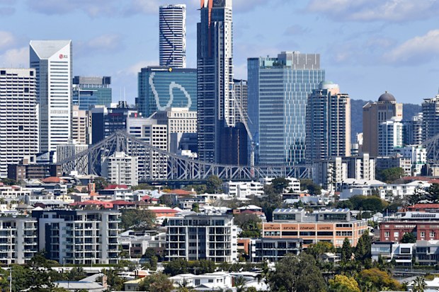 Houses and apartment buildings are seen against the Brisbane CBD skyline in Brisbane.