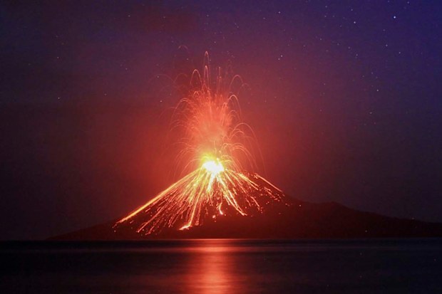 A long exposure photo shows lava erupting from Mount Anak Krakatau volcano as seen from Rakata Island in Lampung province, Indonesia, 19 July 2018 (reissued 23 December 2018). A tsunami that hit coastal areas around Indonesia's Sunda Straight has killed at least 43 people and injured over 580 others. Local authorities believe the tsunami may have been caused by volcanic activity related to Anak Krakatau.