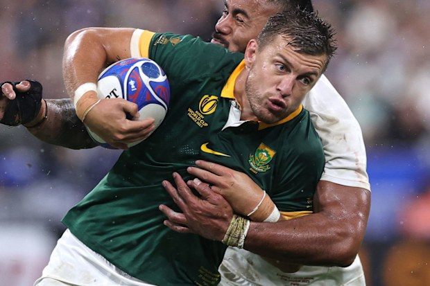 Handre Pollard of South Africa is held by Manu Tuilagi during the Rugby World Cup France 2023 semi final match between England and South Africa.