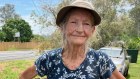 Narelle Cole lives across the road from a flood warning sign. Insurance against such disasters is too expensive, the pensioner says. 