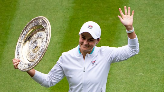 Ash Barty lifts the trophy after winning Wimbledon.