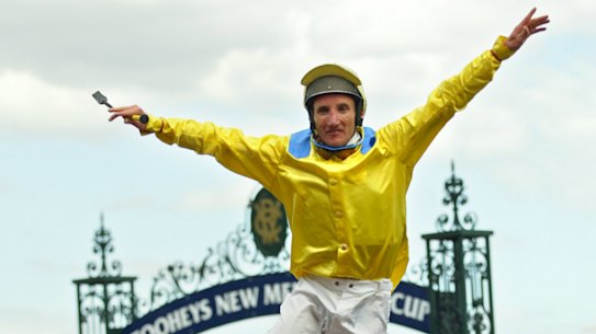 Damien Oliver jumping off Media Puzzle after his incredible 2002 Melbourne Cup win.