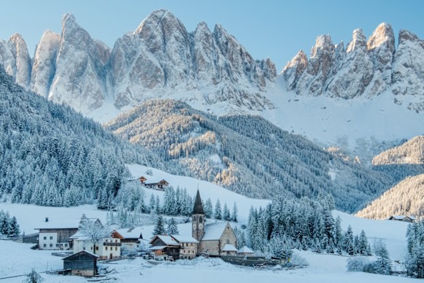 The small village Val di Funes covered in snow, with Dolomites mountains, South Tyrol, Italy.