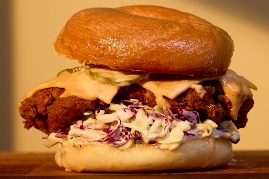 “The Tokyo” fried chicken bagel with cabbage slaw, provolone cheese and chilli-mayo at Roman’s Deli.
