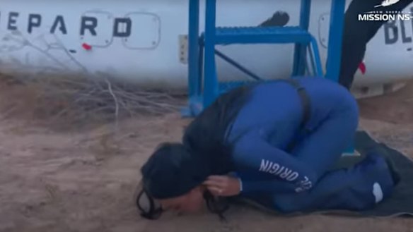 Singer Katy Perry kisses the ground after touch down.