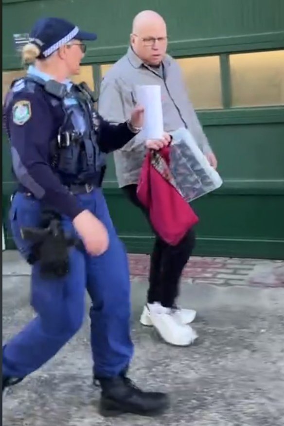 Cooke with a police officer after the alleged altercation outside court.
