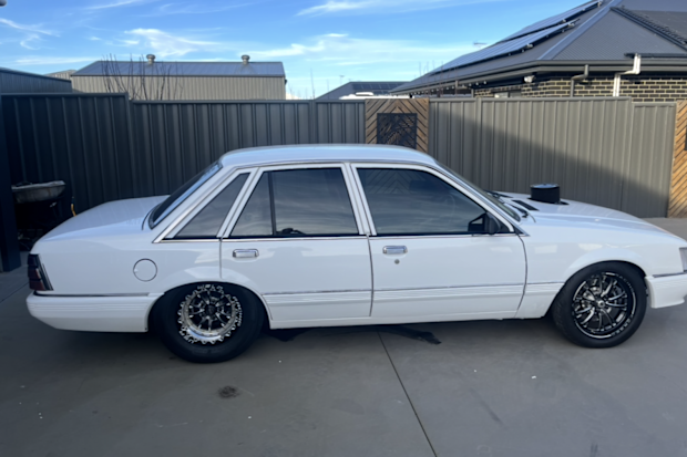 The white 1986 VK Holden Commodore with no rego was one of two vintage cars stolen from the Virginia property.