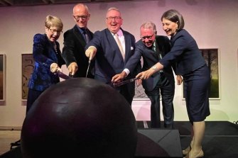 NSW Governor Margaret Beazley, AGNSW director Michael Brand, then-arts minister Don Harwin, AGNSW president David Gonski and then-premier Gladys Berejiklian cut the controversial cake to celebrate the 150th birthday of the Art Gallery of NSW. 
