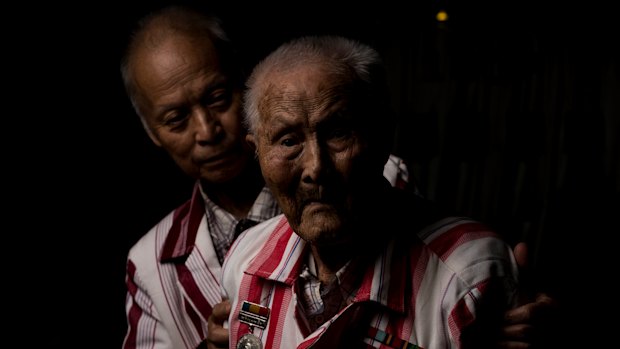 Bordy Weeku, seen with his son Eh Htoo Saw, served in the the British Army in the Second World War. He's now 100 and lives in Werribee.