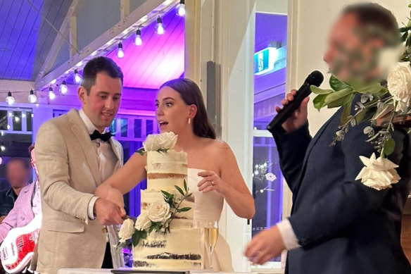 Mitchell Gaffney and Maddy Edsell cutting their wedding cake.