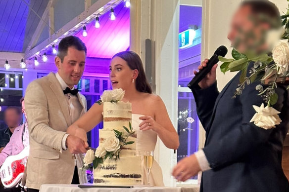 Mitchell Gaffney and Maddy Edsell cutting their wedding cake.