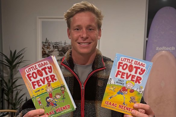 Isaac Heeney with his first two children’s books, First Bounce and Game On.