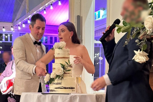 Mitchell Gaffney and Maddy Edsell cutting their wedding cake.