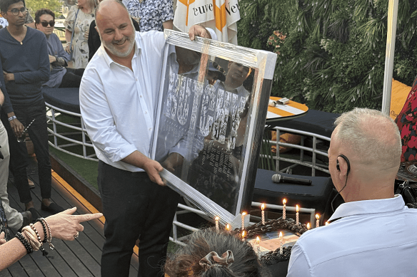 Craig Hutchison receives a present from his SEN team.