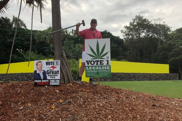 Rubbing it in: Bernie Bradley erecting a corflute outside Clive Palmer’s Coolum resort during the campaign.