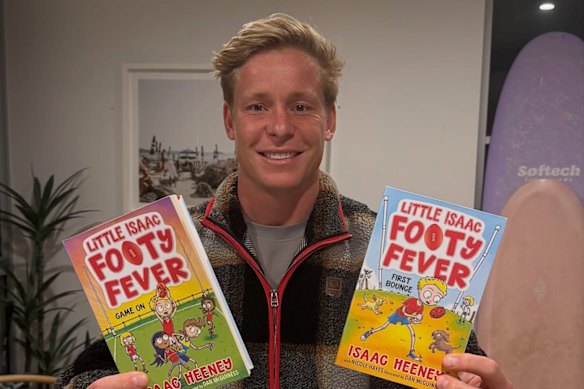 Isaac Heeney with his first two children’s books, First Bounce and Game On.