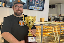 Mitchell holding their gourmet sausage roll trophy.