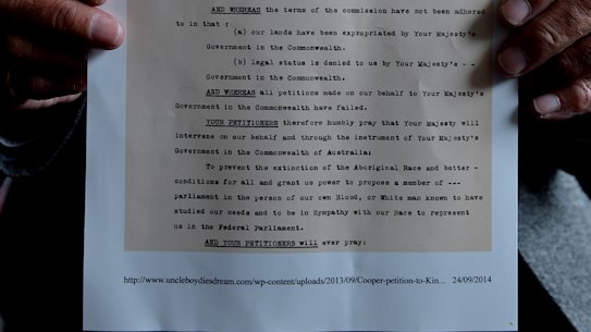 Uncle Boydie Turner with a copy of the petition originally written by his grandfather William Cooper for Aboriginal representation in parliament.