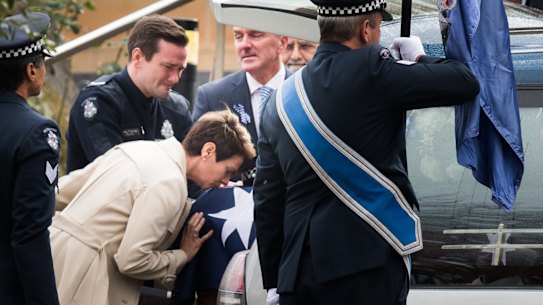 Constable Josh Prestney's mother Belinda kisses the casket, with son Alex and husband Andrew. 