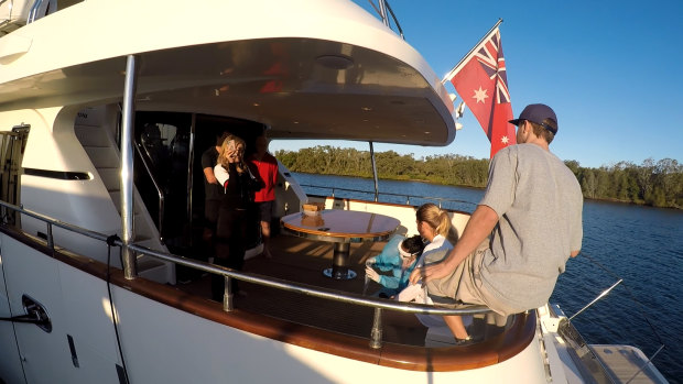 A nurse tests Hannah Fox for COVID-19 on yacht the Lady Pamela, moored at the Gold Coast City Marina