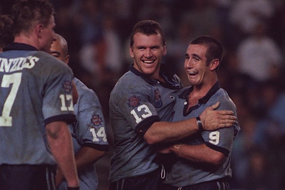 Andrew Johns (right) and Adam Muir celebrate a NSW victory.
