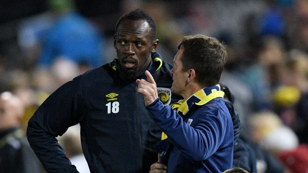 Last-minute instructions: Mariners coach Mike Mulvey has a final word with Usain Bolt before the sprint star takes the field.