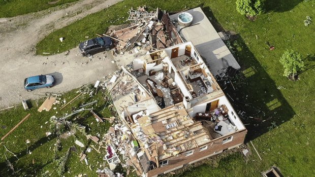 Storm damaged homes remain after a tornado passed through the area the previous evening.