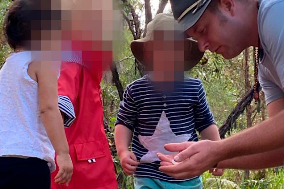 Photos showing Tait talking to children in a forest area were published online.